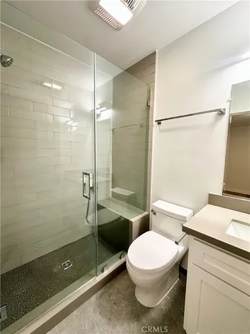 a bathroom with a toilet a sink and shower