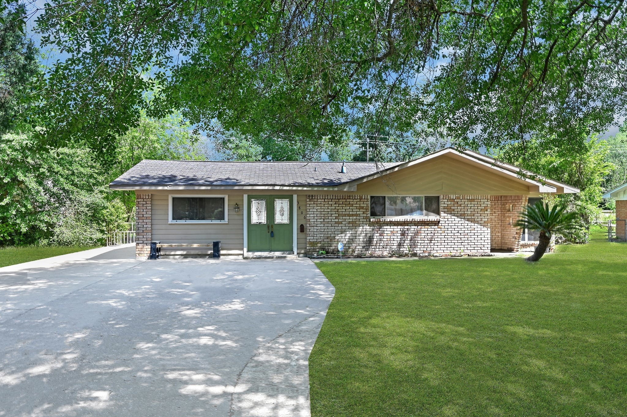 a front view of a house with a garden and yard