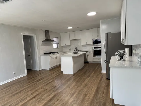 a kitchen with a sink stainless steel appliances and cabinets