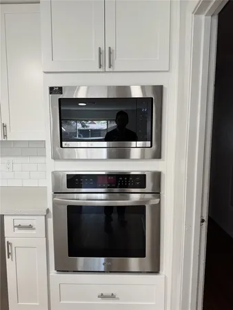 a stove top oven sitting inside of a kitchen