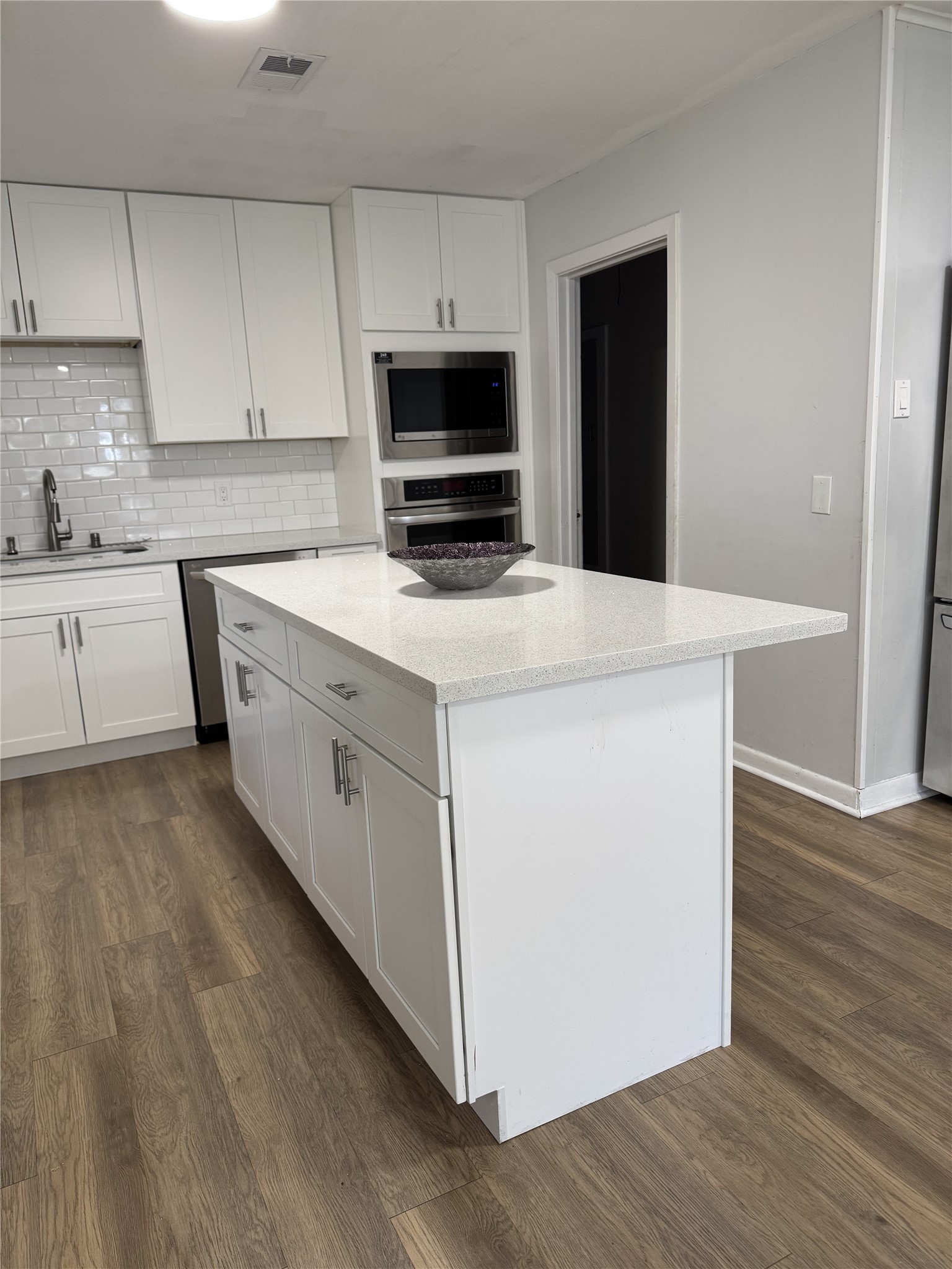 3806 Tilson Lane Houston, TX 77080 - Photo 7 of 13 a kitchen with a stove top oven and white cabinets