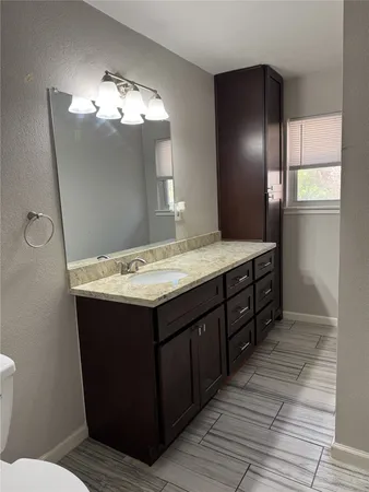 a bathroom with a sink vanity and a mirror