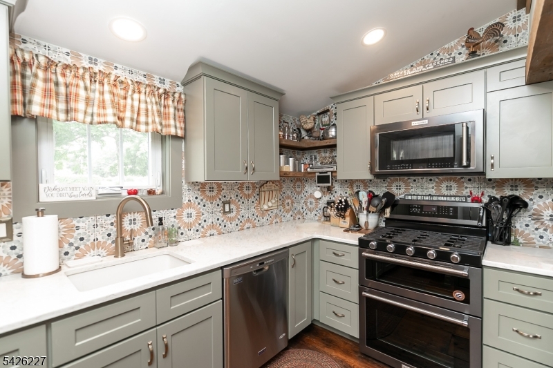 36 Main Street Flanders, NJ 07836 - Photo 10 of 49 a kitchen with stainless steel appliances a stove a sink and a microwave