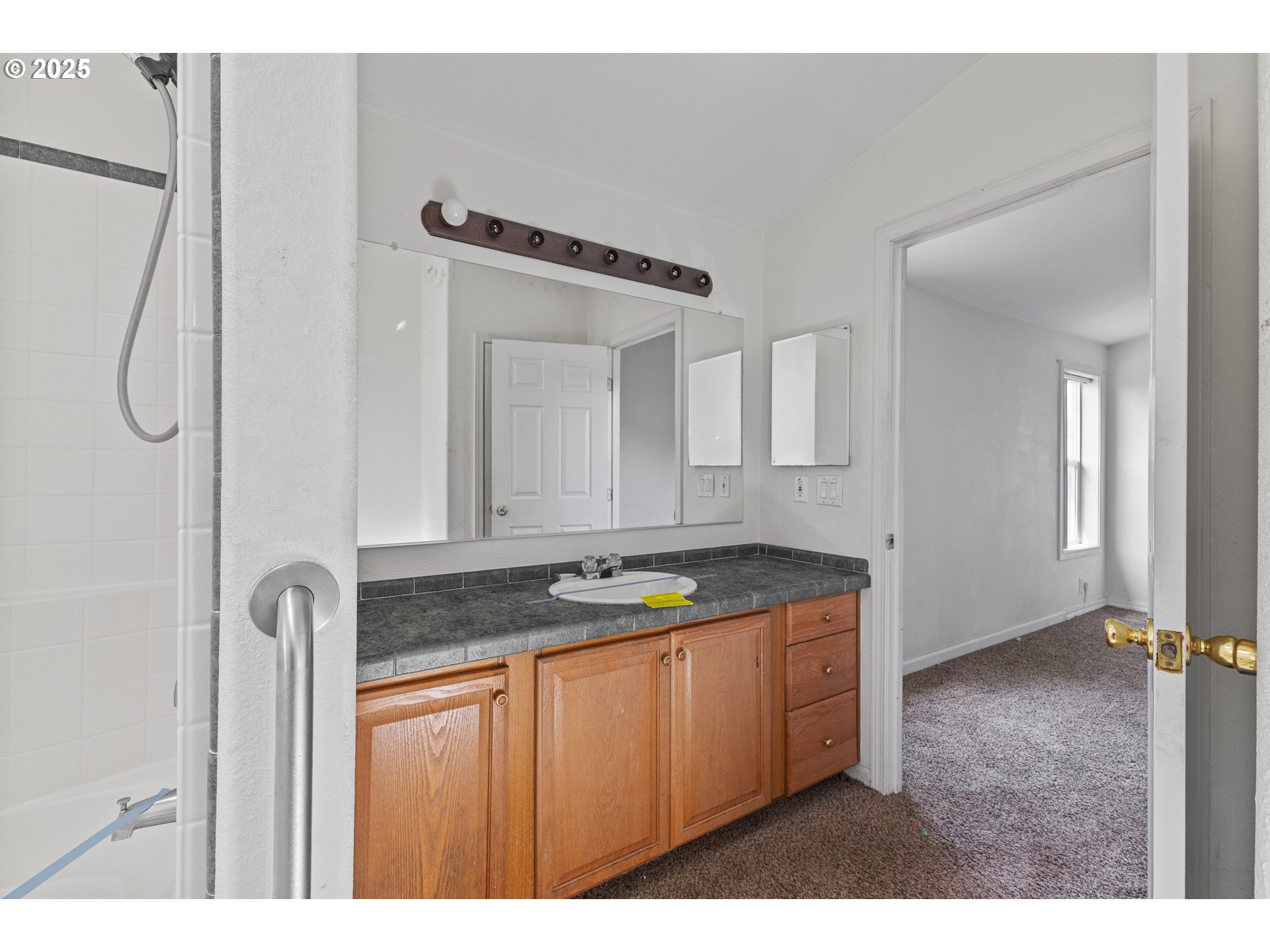 1829 East Willow Street Myrtle Point, OR 97458 - Photo 24 of 37 a bathroom with a granite countertop sink and a mirror