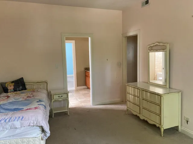a bedroom with a bed and a cabinets