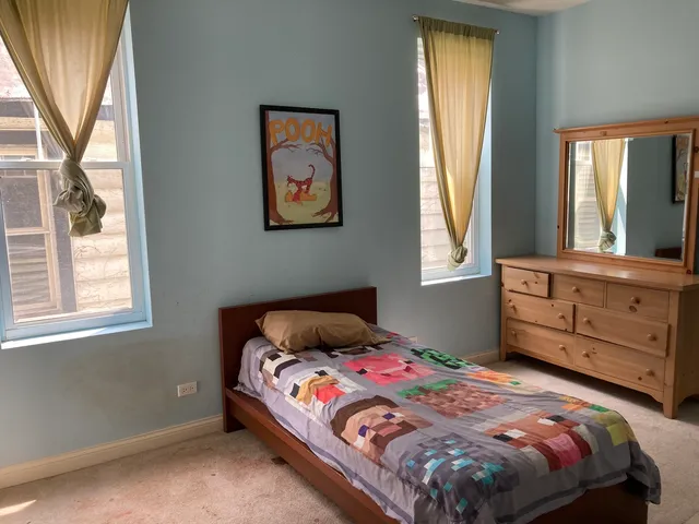 a bedroom with a bed and a window