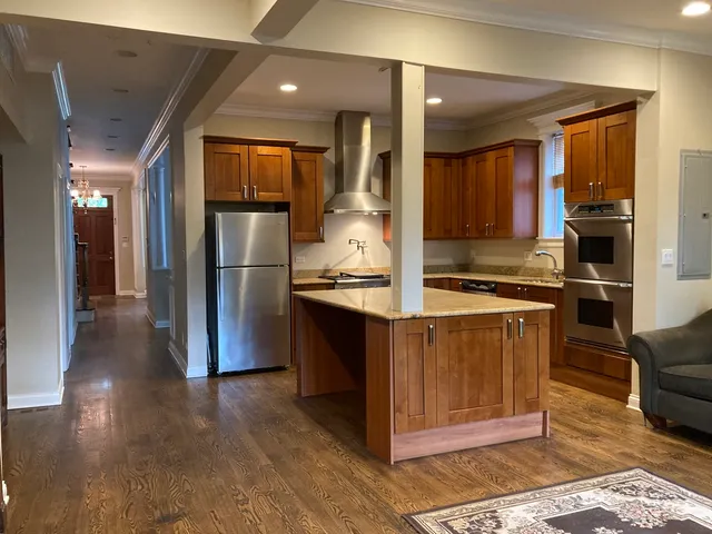 a kitchen with stainless steel appliances granite countertop a refrigerator and a stove