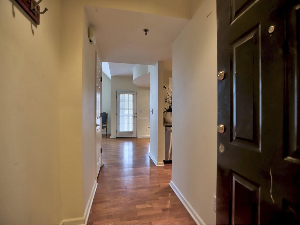 3636 Habersham Road Northwest, Unit 2308 Atlanta, GA 30305 - Photo 26 of 43 a view of a hallway with wooden floor and closet