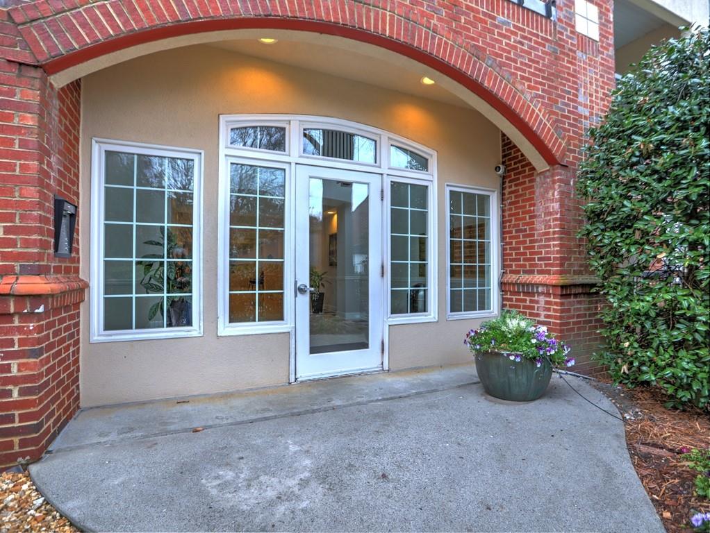 3636 Habersham Road Northwest, Unit 2308 Atlanta, GA 30305 - Photo 27 of 43 a front view of a house with a yard