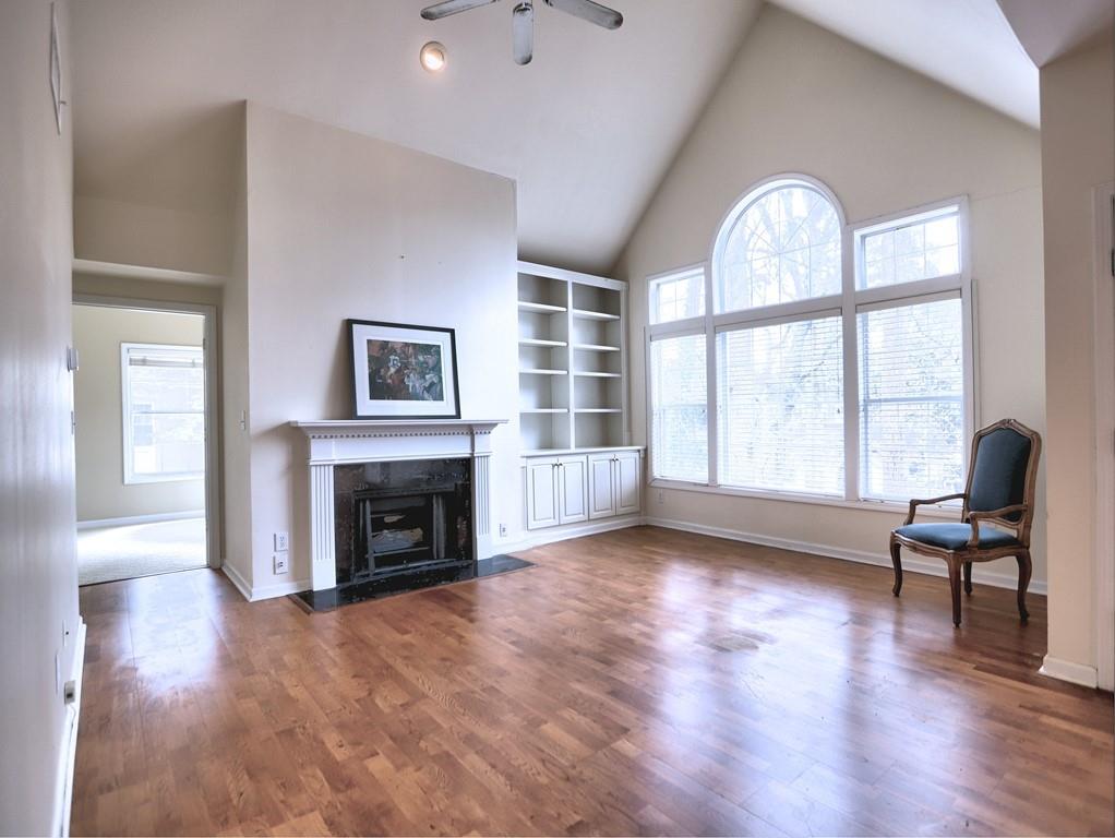 3636 Habersham Road Northwest, Unit 2308 Atlanta, GA 30305 - Photo 4 of 43 a view of a livingroom with furniture a fireplace and wooden floor