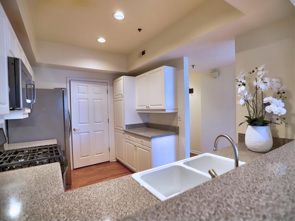 3636 Habersham Road Northwest, Unit 2308 Atlanta, GA 30305 - Photo 6 of 43 a kitchen with stainless steel appliances granite countertop a stove a sink and a granite counter tops