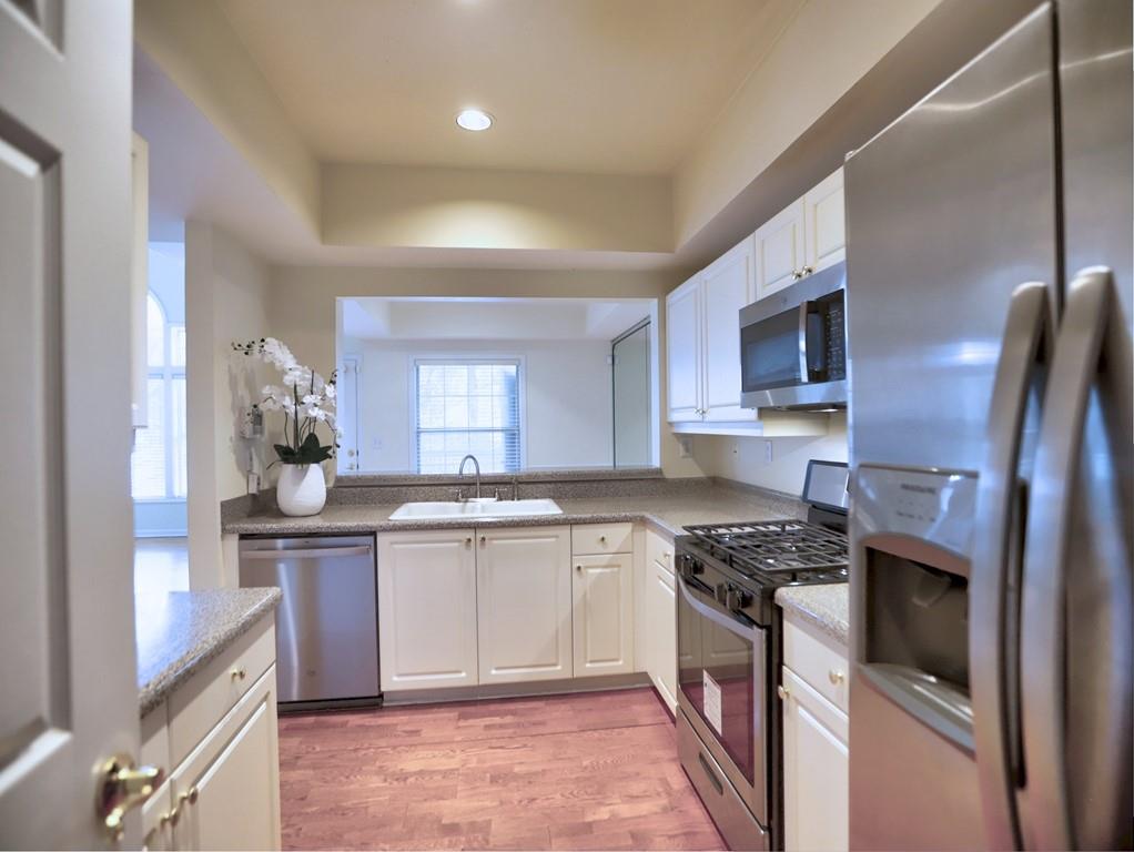 3636 Habersham Road Northwest, Unit 2308 Atlanta, GA 30305 - Photo 9 of 43 a kitchen with stainless steel appliances granite countertop a sink stove refrigerator and cabinets
