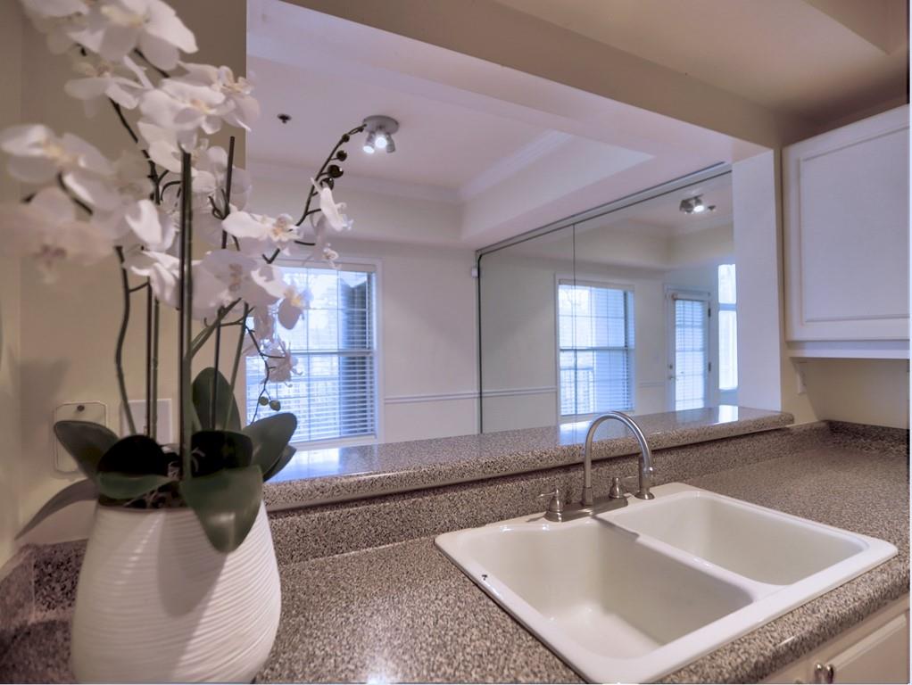 3636 Habersham Road Northwest, Unit 2308 Atlanta, GA 30305 - Photo 10 of 43 a bathroom with a sink a vanity and mirror
