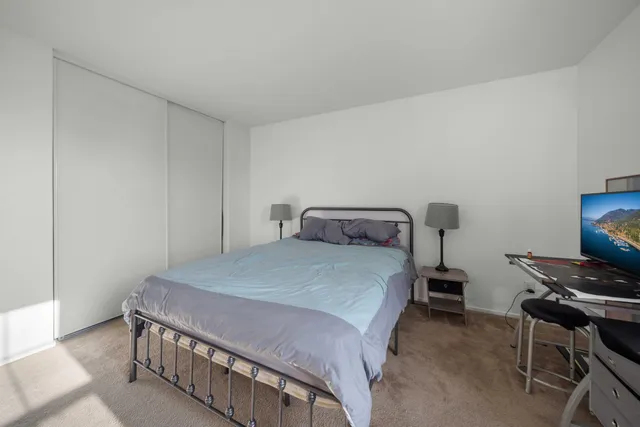 a bedroom with a bed and a window