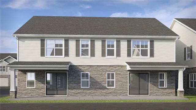 a front view of a house with yard and parking