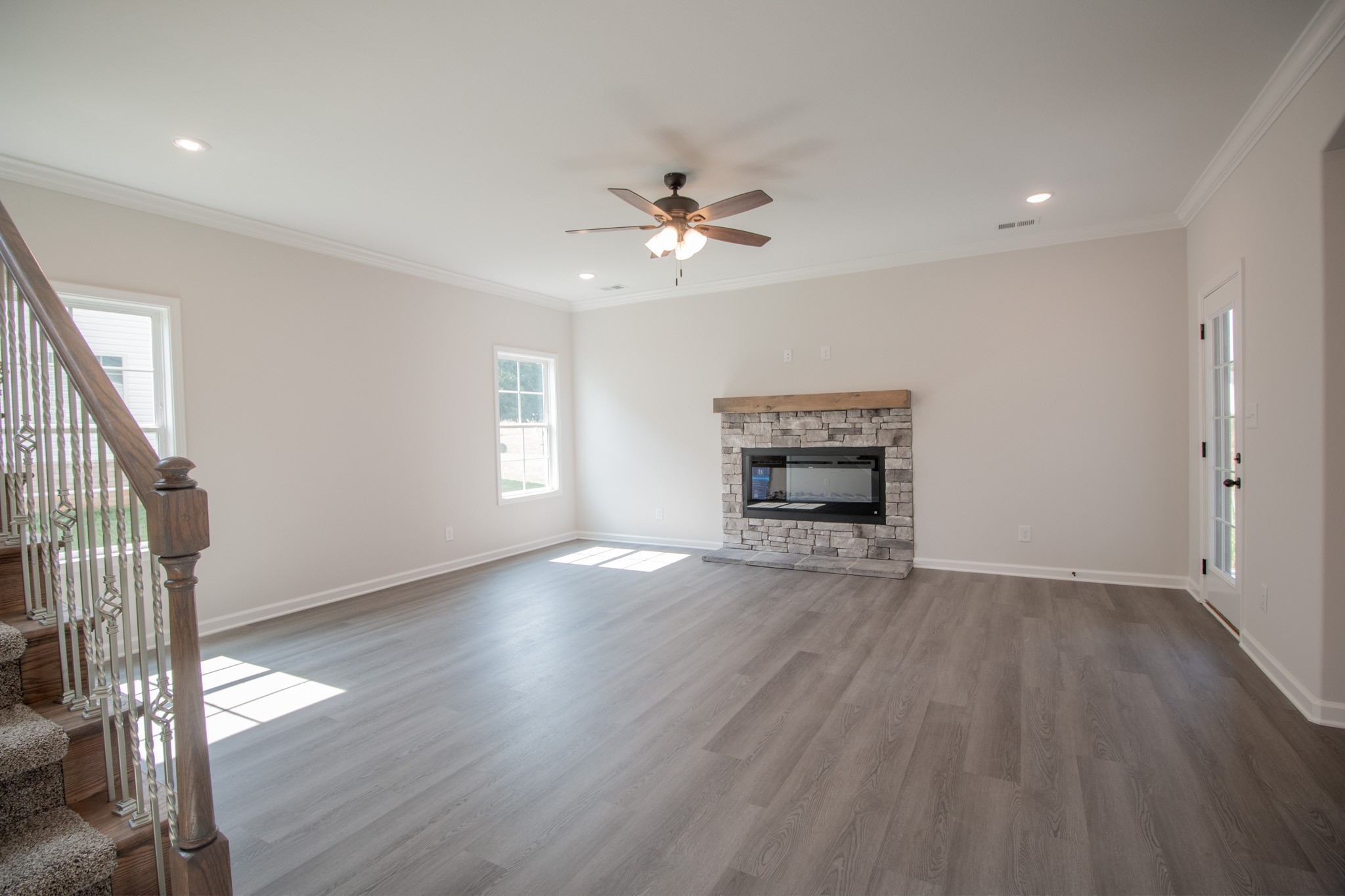 362 Timber Springs Clarksville, TN 37042 - Photo 4 of 24 an empty room with wooden floor ceiling fan and windows