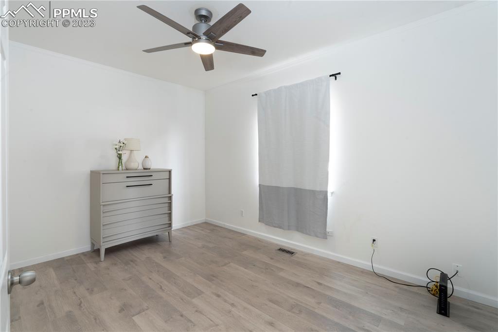827 Circle Road Palmer Lake, CO 80133 - Photo 11 of 28 a view of an empty room and window ceiling fan