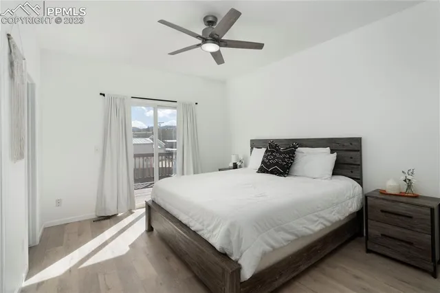 a bedroom with a bed and large window