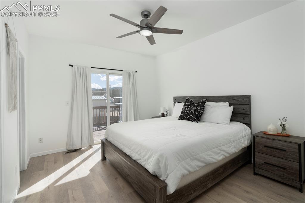 827 Circle Road Palmer Lake, CO 80133 - Photo 13 of 28 a bedroom with a bed and large window