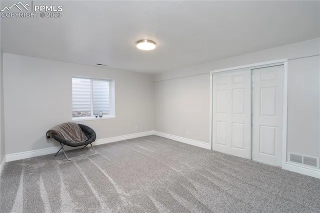 a bedroom with a bed and a chair