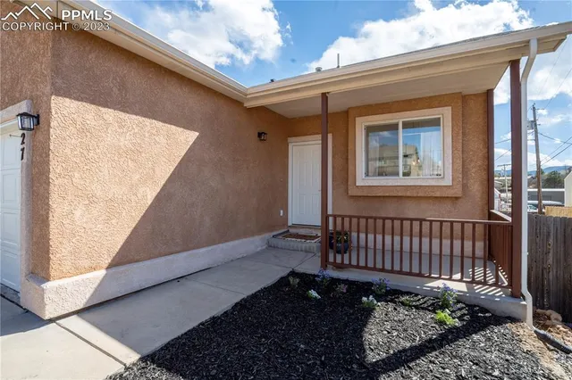 a view of a house with a wooden fence