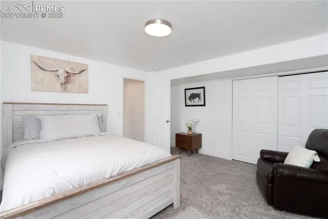 a bedroom with a bed and couch