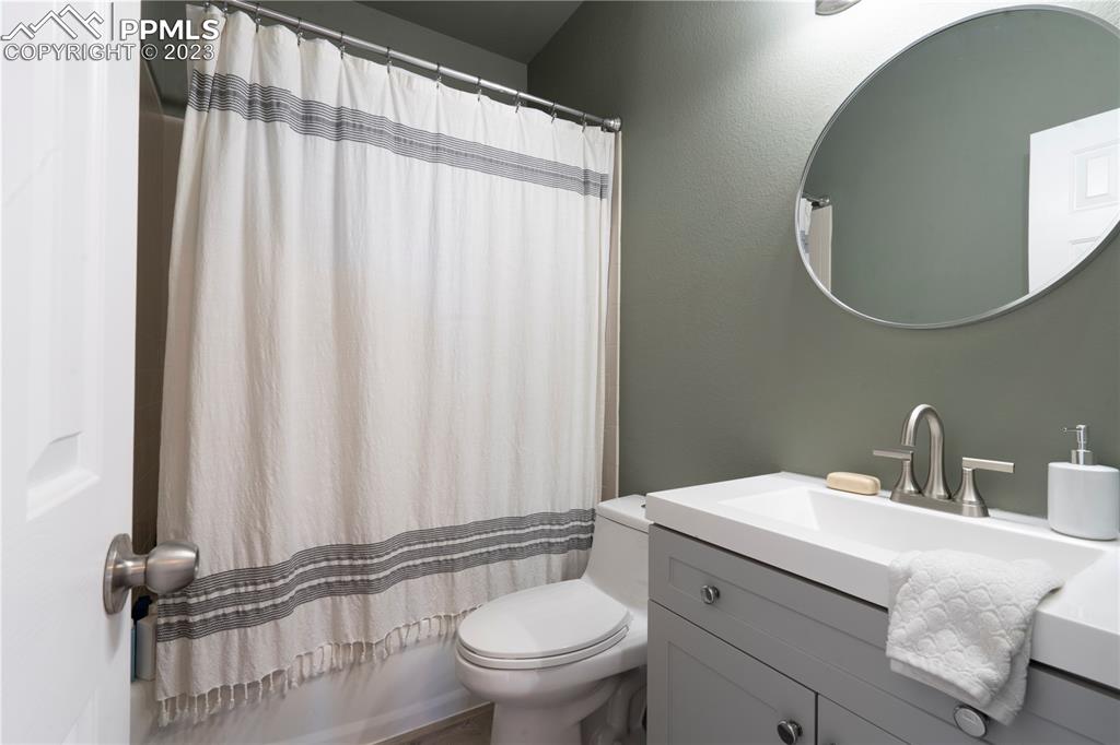 827 Circle Road Palmer Lake, CO 80133 - Photo 23 of 28 a bathroom with a sink a toilet and a mirror