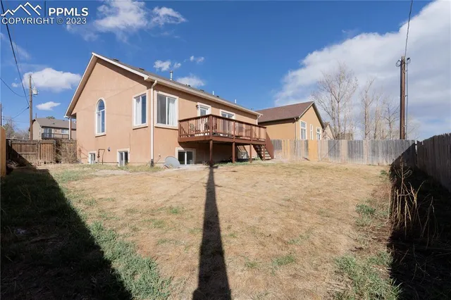 a view of a white house with a yard
