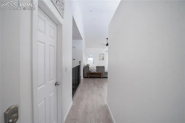 a view of a hallway with a livingroom and a bathroom