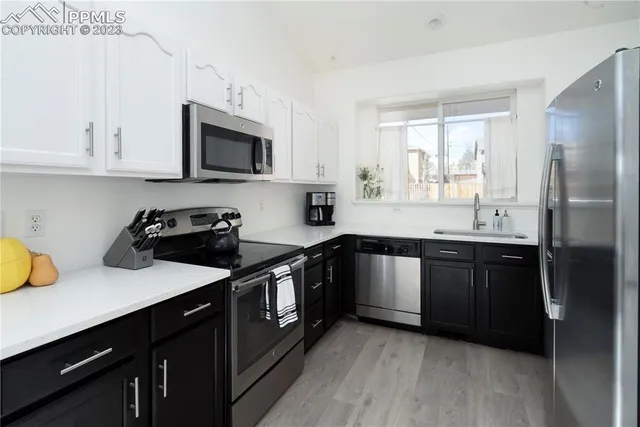 a kitchen with a sink stove and microwave