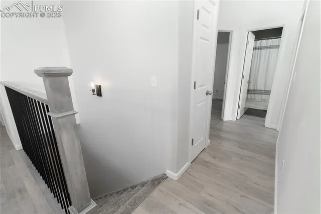 a view of a hallway with wooden floor