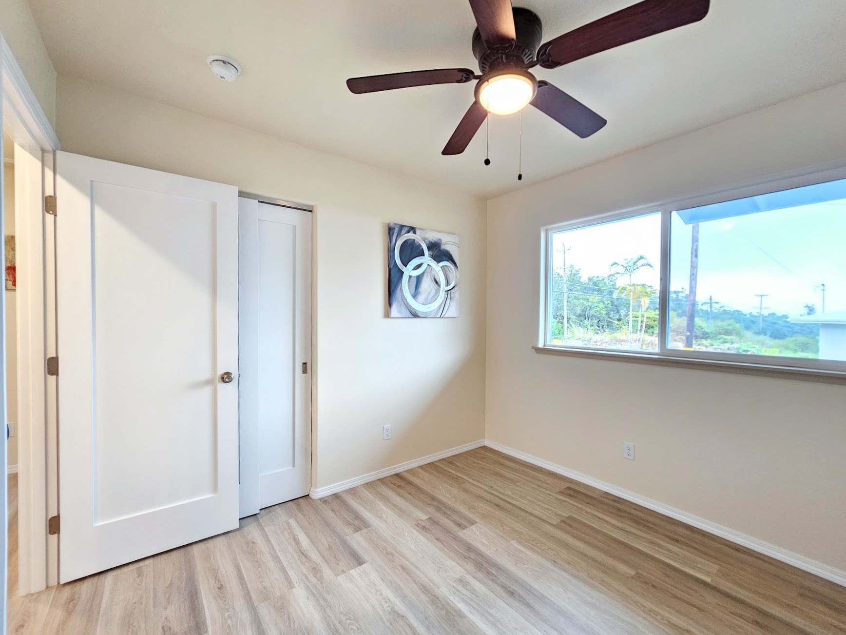 11-3387 Old Volcano Road Volcano, HI 96785 - Photo 18 of 24 a view of empty room with wooden floor and fan