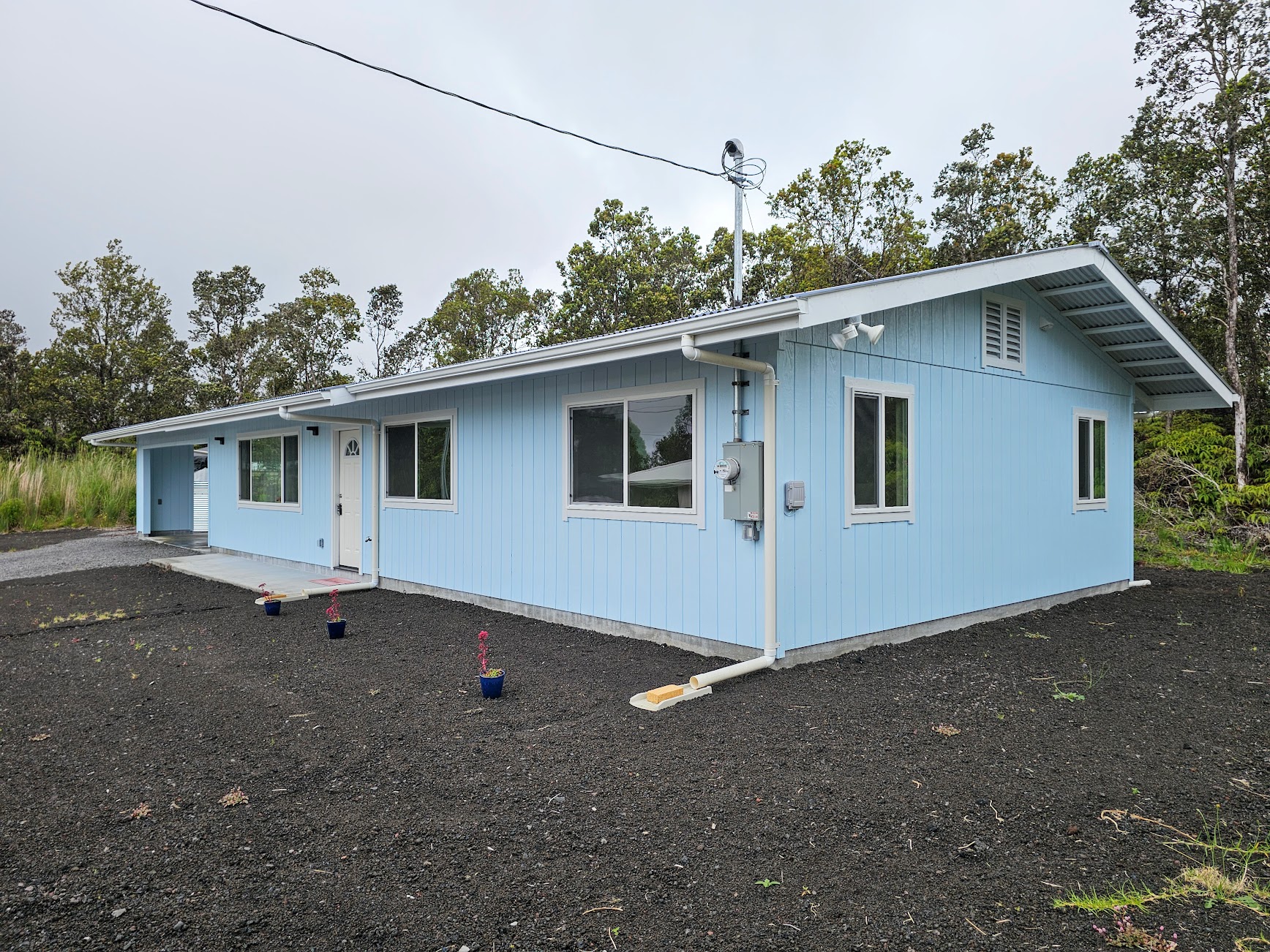 11-3387 Old Volcano Road Volcano, HI 96785 - Photo 8 of 24 a house with a tree in the background