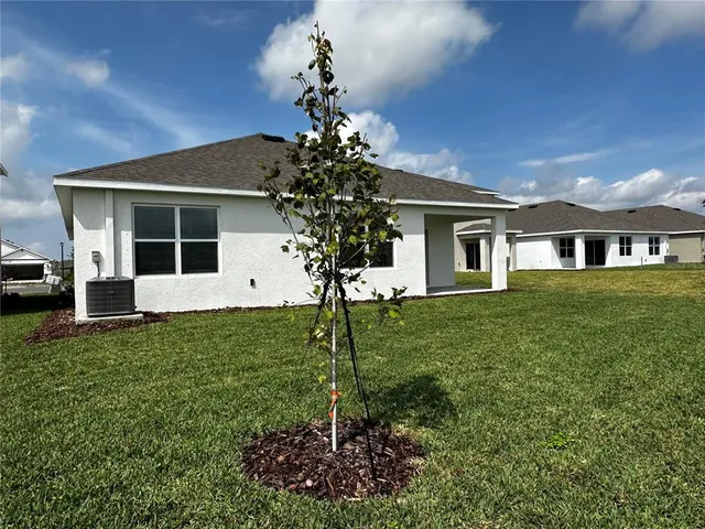 a view of swimming pool with outdoor seating and lake view