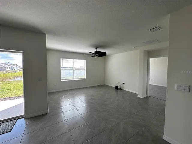 a bathroom with a granite countertop sink mirror vanity and toilet