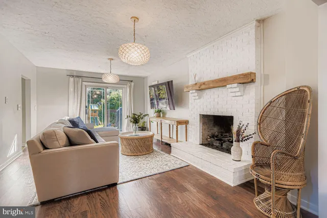 a living room with furniture a fireplace and a table