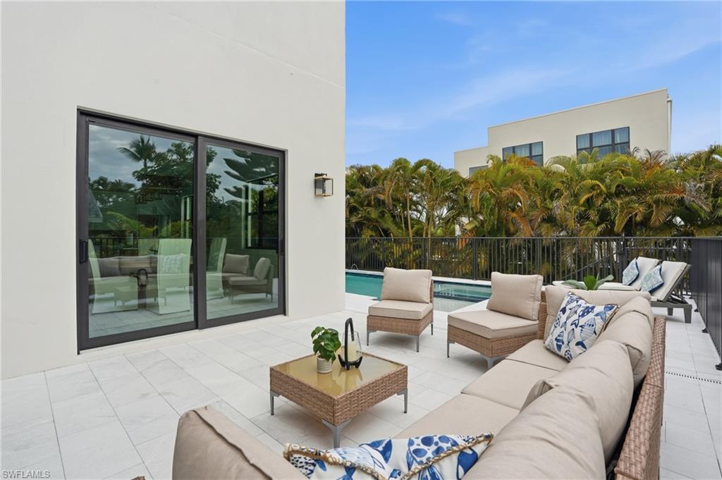 107 West Hilo Street Naples, FL 34113 - Photo 27 of 33 a outdoor living space with furniture and garden view