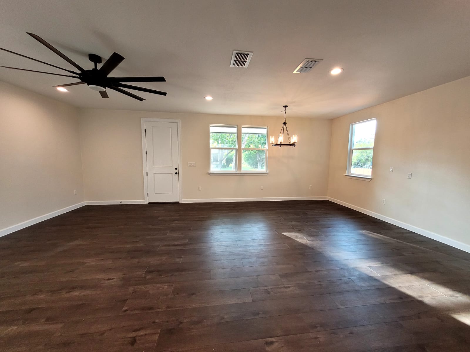750 South Main Street Lockhart, TX 78644 - Photo 7 of 31 Spare room with a chandelier, dark wood-style floors, and ceiling fan
