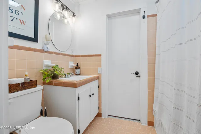 a bathroom with a sink a mirror and a toilet