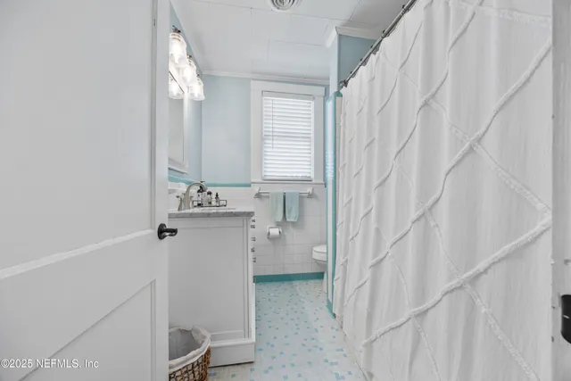 a bathroom with a sink a mirror and a shower