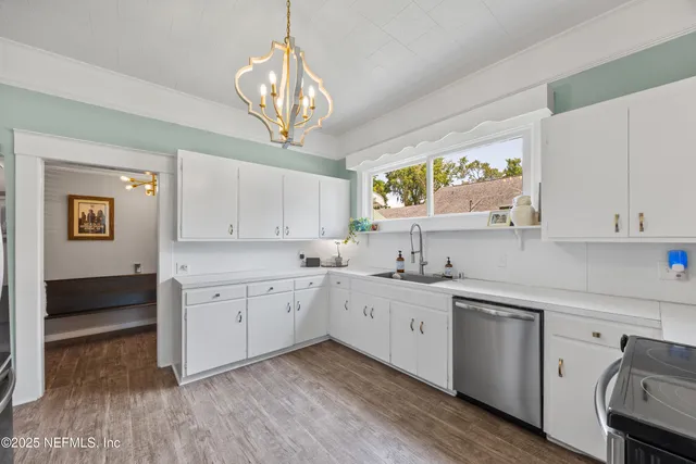 a kitchen with a sink cabinets and window