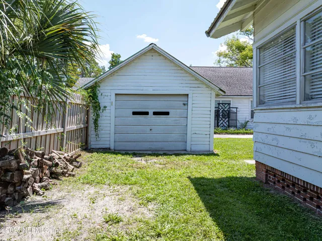 a view of a backyard with wooden fence