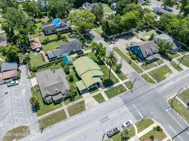an aerial view of a house with a yard basket ball court and outdoor seating