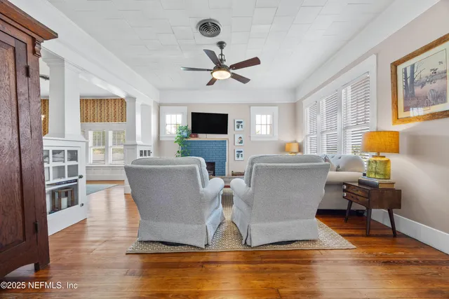 a living room with fireplace furniture and a flat screen tv