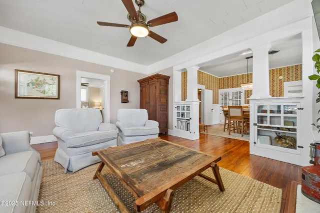 a living room with furniture a rug and a chandelier