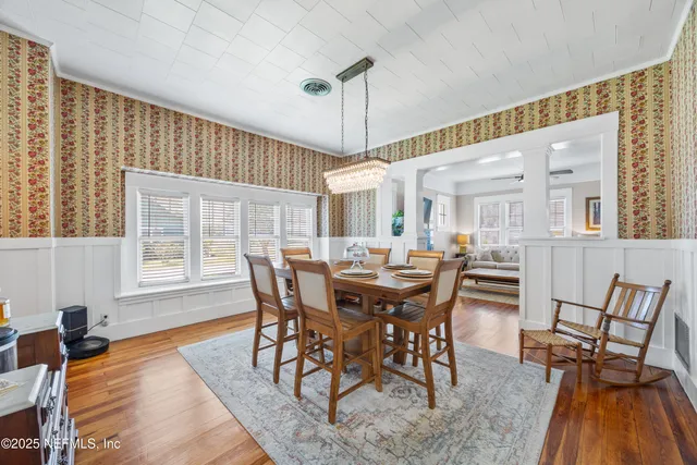 a view of a dining room with furniture window and wooden floor