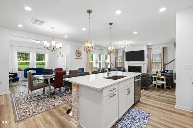 a large kitchen with kitchen island a sink table and chairs
