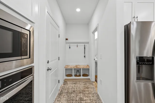 a view of a kitchen with refrigerator and kitchen