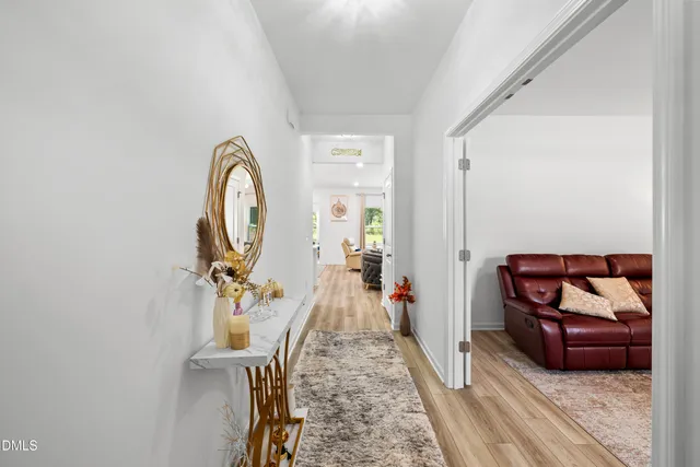 a living room with furniture and a wooden floor