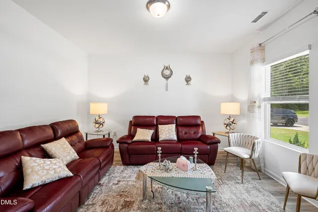 a living room with furniture a rug and a window